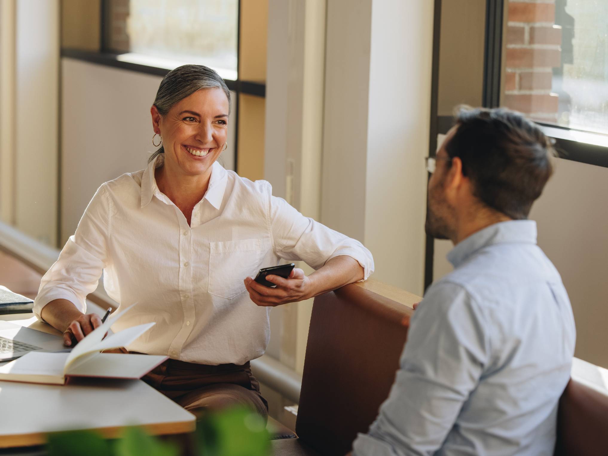 Symbolbild: Frau und Mann unterhalten sich im Büro.